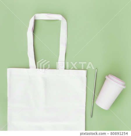 Eco paper bag flat lay on green background 80891254