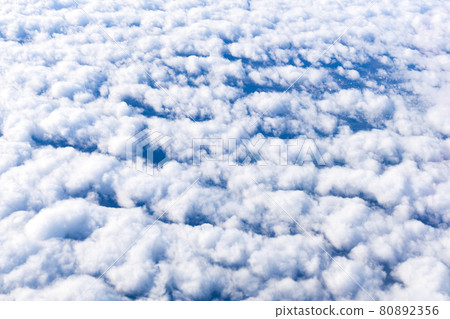 Blue sky with white clouds background with copy space for text, sky wallpaper. View from the plane window 80892356