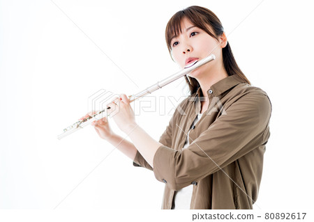 一個穿著休閒裝吹長笛的女人 一個穿著休閒裝吹長笛的女人 80892617