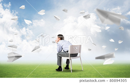Young businessman sitting on an office chair Young businessman sitting on an office chair 80894305