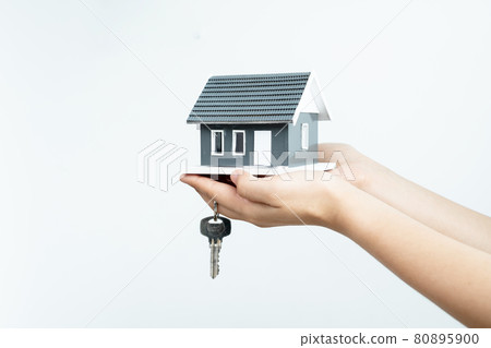 The hand of the real estate agent holding the house model and the keys Loan and home concept The hand of the real estate agent holding the house model and the keys Loan and home concept 80895900