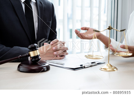 A male lawyer or a judge counseling clients about judicial justice and prosecution with scales, judges gavel, legal documents legal services concept A male lawyer or a judge counseling clients about judicial justice and prosecution with scales, judges gavel, legal documents legal services concept 80895935