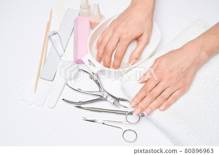 Beautiful Female Hands with French manicure over light grey background 80896963