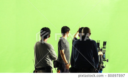 Video production behind the scenes. Making of TV commercial movie that film crew team lightman and cameraman working together with film director in studio. film production concept. Silhouette style. 80897897