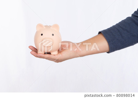 Hand holding a pink piggy bank isolated on white background Hand holding a pink piggy bank isolated on white background 80898014