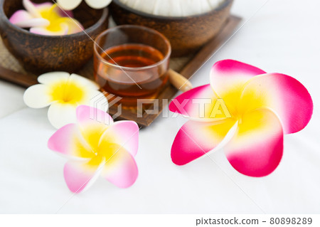 Set of spa treatments, natural oil, and plumeria flowers 80898289