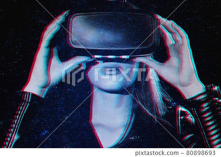 girl in virtual reality glasses is immersed in augmented reality with the help of modern technologies 80898693