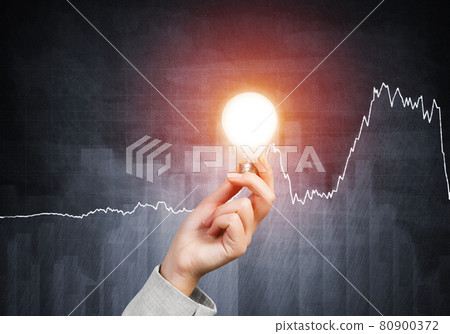 Human hand with glowing incandescent lamp Human hand with glowing incandescent lamp 80900372