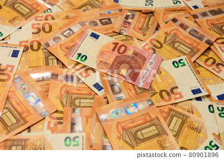 Banknotes in denominations of and euros are scattered randomly on the background, the texture of the European currency. Banknotes in denominations of and euros are scattered randomly on the background, the texture of the European currency. 80901896