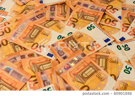 Banknotes in the denomination euros are scattered randomly on the background, the texture of the European currency. Banknotes in the denomination euros are scattered randomly on the background, the texture of the European currency. 80901898