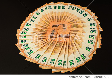 Pile real euro banknotes isolated on a black background. Pile real euro banknotes isolated on a black background. 80901899