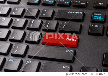 OMG red key on a black pc keyboard. Desktop keyboard with Omg gamer slang button. 80903074