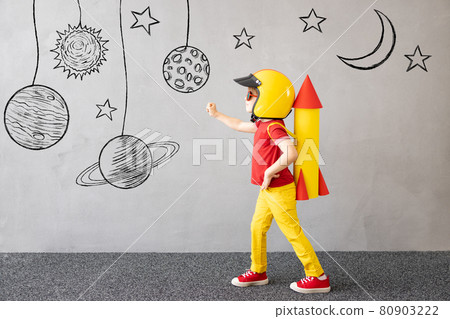 Happy child playing with toy paper rocket Happy child playing with toy paper rocket 80903222