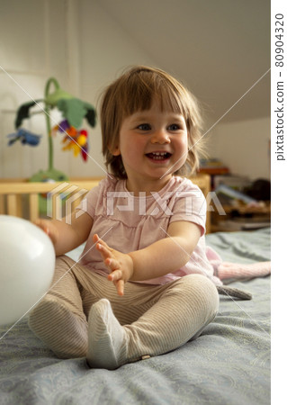 Cute todler, baby lifestyle portrait, smiling and playing at home. Child education, parenting concept. 80904320