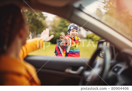 Mother dropped off her little cute child near the school 80904406