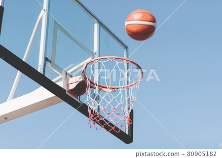 Sports and recreation concept a basketball shot flowing on the air to a basketball hoop Sports and recreation concept a basketball shot flowing on the air to a basketball hoop 80905182
