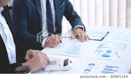 Business concept a couple of business partners calculating annual income and expense for creating the next financial plan. 80905184