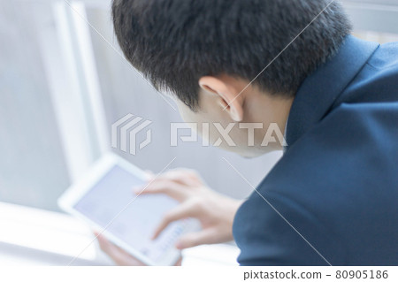 Business partners concept a young businessman wearing navy suit jacket looking on the tablet screen checking an email inbox Business partners concept a young businessman wearing navy suit jacket looking on the tablet screen checking an email inbox 80905186