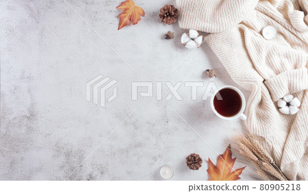Autumn composition. A cup of coffee, cotton flowers, autumn leaves and sweater on stone background. Flat lay, top view with copy space. Autumn composition. A cup of coffee, cotton flowers, autumn leaves and sweater on stone background. Flat lay, top view with copy space. 80905218