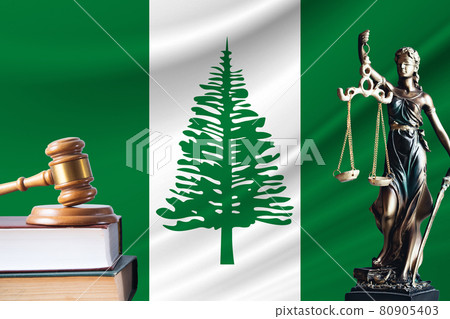 Law and justice in Norfolk Island. Statue of themis and the gavel of the judge against the background of the flag of Norfolk Island. Law and justice concept 80905403