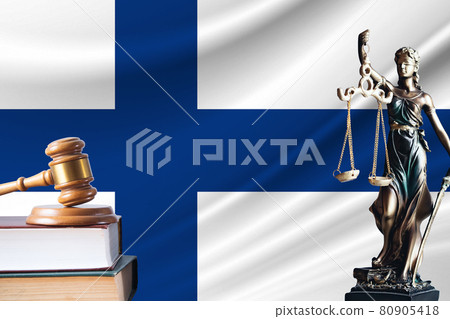Law and justice in Finland. Statue of themis and the gavel of the judge against the background of the flag of Finland. Law and justice concept Law and justice in Finland. Statue of themis and the gavel of the judge against the background of the flag of Finland. Law and justice concept 80905418