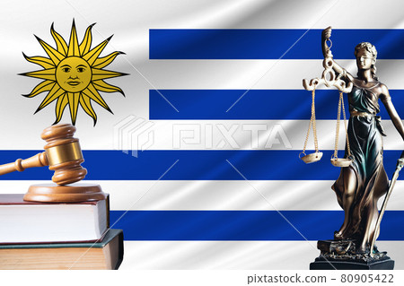 Law and justice in Uruguay. Statue of themis and the gavel of the judge against the background of the flag of Uruguay. Law and justice concept 80905422