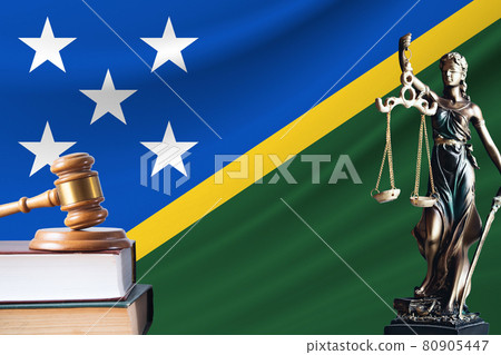 Law and justice in Solomon Islands. Statue of themis and the gavel of the judge against the background of the flag of Solomon Islands. Law and justice concept Law and justice in Solomon Islands. Statue of themis and the gavel of the judge against the background of the flag of Solomon Islands. Law and justice concept 80905447