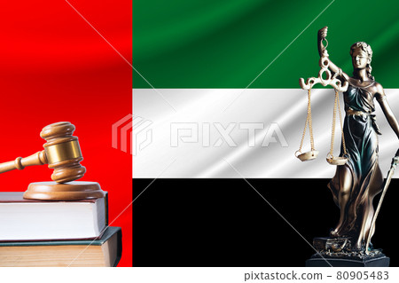 Law and justice in United Arab Emirates. Statue of themis and the gavel of the judge against the background of the flag of United Arab Emirates. Law and justice concept Law and justice in United Arab Emirates. Statue of themis and the gavel of the judge against the background of the flag of United Arab Emirates. Law and justice concept 80905483