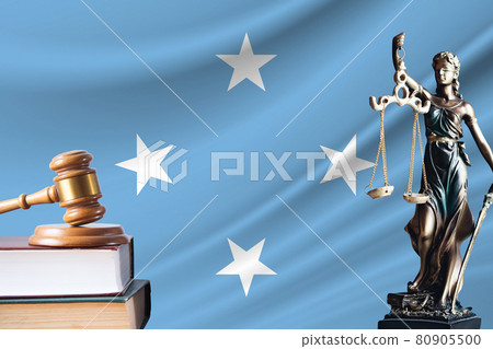 Law and justice in Federated States of Micronesia. Statue of themis and the gavel of the judge against the background of the flag of Federated States of Micronesia. Law and justice concept 80905500
