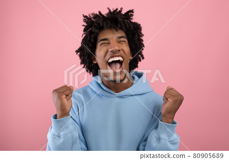 Huge win, great luck. Handsome African American teenager making YES gesture, shouting OMG on pink studio background Huge win, great luck. Handsome African American teenager making YES gesture, shouting OMG on pink studio background 80905689