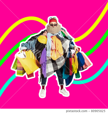 Sales concept. One young man dressed in many bright clothes holding a lot of paper bags. Black friday, fashion, ad concept 80905825