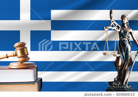 Law and justice in Greece. Statue of themis and the gavel of the judge against the background of the flag of Greece. Law and justice concept 80906010