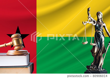 Law and justice in Guinea-Bissau. Statue of themis and the gavel of the judge against the background of the flag of Guinea-Bissau. Law and justice concept 80906014