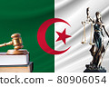 Law and justice in Algeria. Statue of themis and the gavel of the judge against the background of the flag of Algeria. Law and justice concept 80906054