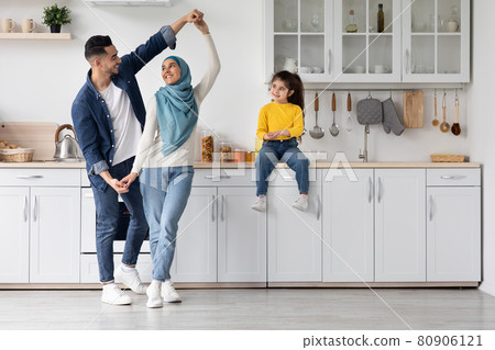 Portrait Of Happy Arab Family Of Three Having Fun In Kitchen Interior 80906121