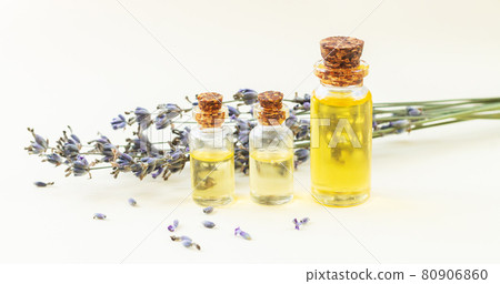 Glass bottles of lavender essential oil or natural perfume with dried lavender flowers 80906860