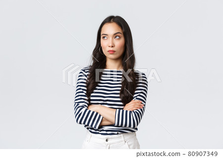 Lifestyle, beauty and fashion, people emotions concept. Annoyed and uninterested asian woman roll eyes, looking away bothered and bored, cross arms chest, standing white background Lifestyle, beauty and fashion, people emotions concept. Annoyed and uninterested asian woman roll eyes, looking away bothered and bored, cross arms chest, standing white background 80907349