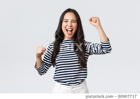 Lifestyle, people emotions and casual concept. Excited happy asian woman attend sport competition, rooting and chanting for team, raising hands up and shout yes supportive Lifestyle, people emotions and casual concept. Excited happy asian woman attend sport competition, rooting and chanting for team, raising hands up and shout yes supportive 80907717