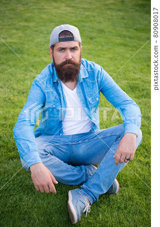 Embracing the streetwear aesthetic. Sexy man sitting Embracing the streetwear aesthetic. Sexy man sitting 80908017