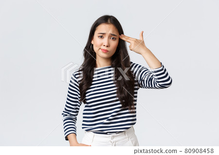 Lifestyle, people emotions and casual concept. Annoyed and pissed-off young woman cant stand this anymore, showing fake gun over head as if shooting herself from annoyance Lifestyle, people emotions and casual concept. Annoyed and pissed-off young woman cant stand this anymore, showing fake gun over head as if shooting herself from annoyance 80908458