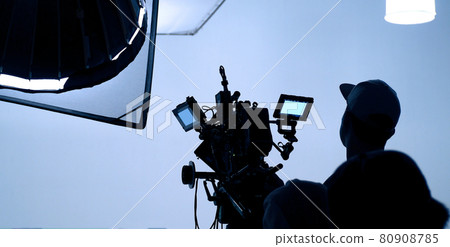 Video production behind the scenes. Making of TV commercial movie that film crew team lightman and cameraman working together with film director in studio. film production concept. Silhouette style. Video production behind the scenes. Making of TV commercial movie that film crew team lightman and cameraman working together with film director in studio. film production concept. Silhouette style. 80908785