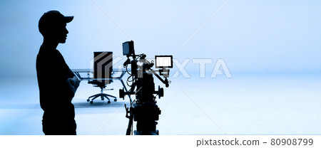 Video production behind the scenes. Making of TV commercial movie that film crew team lightman and cameraman working together with film director in studio. film production concept. Silhouette style. Video production behind the scenes. Making of TV commercial movie that film crew team lightman and cameraman working together with film director in studio. film production concept. Silhouette style. 80908799