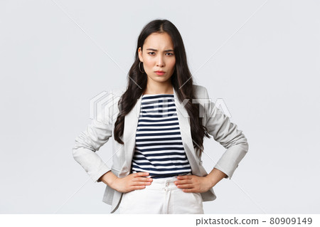 Business, finance and employment, female successful entrepreneurs concept. Mad and disappointed asian businesswoman looking displeased, scold employee who let her down Business, finance and employment, female successful entrepreneurs concept. Mad and disappointed asian businesswoman looking displeased, scold employee who let her down 80909149