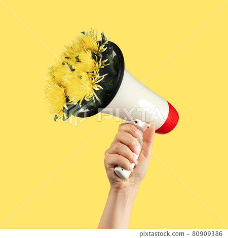 Contemporary art collage. Human hand holding loudspeaker with sticking out flowers on yellow background. Contemporary art collage. Human hand holding loudspeaker with sticking out flowers on yellow background. 80909386