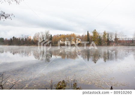 KOUVOLA, FINLAND - OCTOBER 23, 2018: Beautiful wooden Rabbelugn Manor - Takamaan Kartano in fog autumn day. Wrede family house was built in 1820 on the river Kymijoki bank KOUVOLA, FINLAND - OCTOBER 23, 2018: Beautiful wooden Rabbelugn Manor - Takamaan Kartano in fog autumn day. Wrede family house was built in 1820 on the river Kymijoki bank 80910260