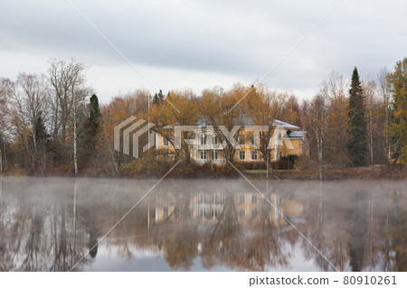 KOUVOLA, FINLAND - OCTOBER 23, 2018: Beautiful wooden Rabbelugn Manor - Takamaan Kartano in fog autumn day. Wrede family house was built in 1820 on the river Kymijoki bank 80910261