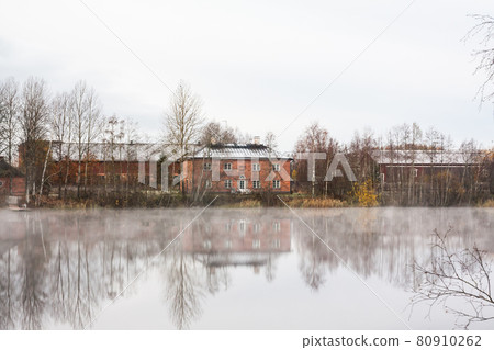 KOUVOLA, FINLAND - OCTOBER 23, 2018: Beautiful wooden Rabbelugn Manor - Takamaan Kartano in fog autumn day. Wrede family house was built in 1820 on the river Kymijoki bank 80910262