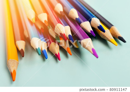 Sharp colored pencils for drawing lie on the table. Accessories for creativity and artists Sharp colored pencils for drawing lie on the table. Accessories for creativity and artists 80911147