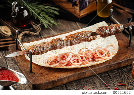 Caucasian beef lyulya kebab with marinated onion 80911692