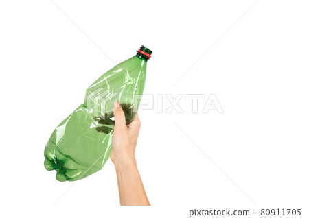 Close-up of a female hand holding a green plastic bottle on a white background. Isolated Close-up of a female hand holding a green plastic bottle on a white background. Isolated 80911705